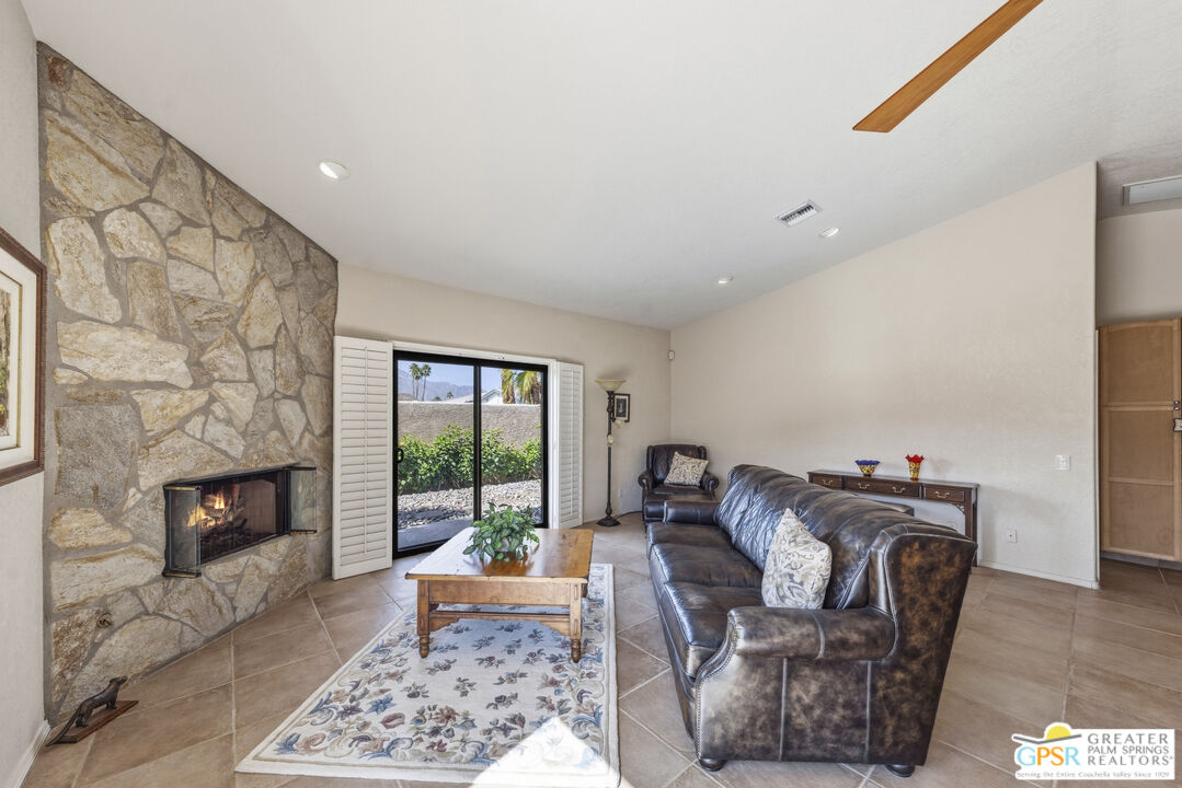 35127 Plumley Road Cathedral City, CA 92234 - Photo 9 of 32 a living room with furniture or couch and a fireplace