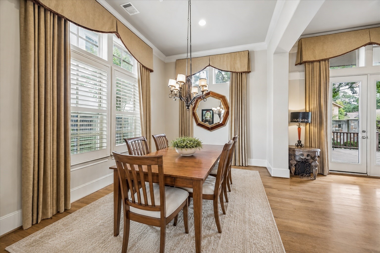 907 Queen Annes Road Houston, TX 77024 - Photo 8 of 31 Formal dining room with oversized windows and seamless flow into the main living spaces — ideal for both everyday living and entertaining. This image has been virtually staged for illustrative purposes.
