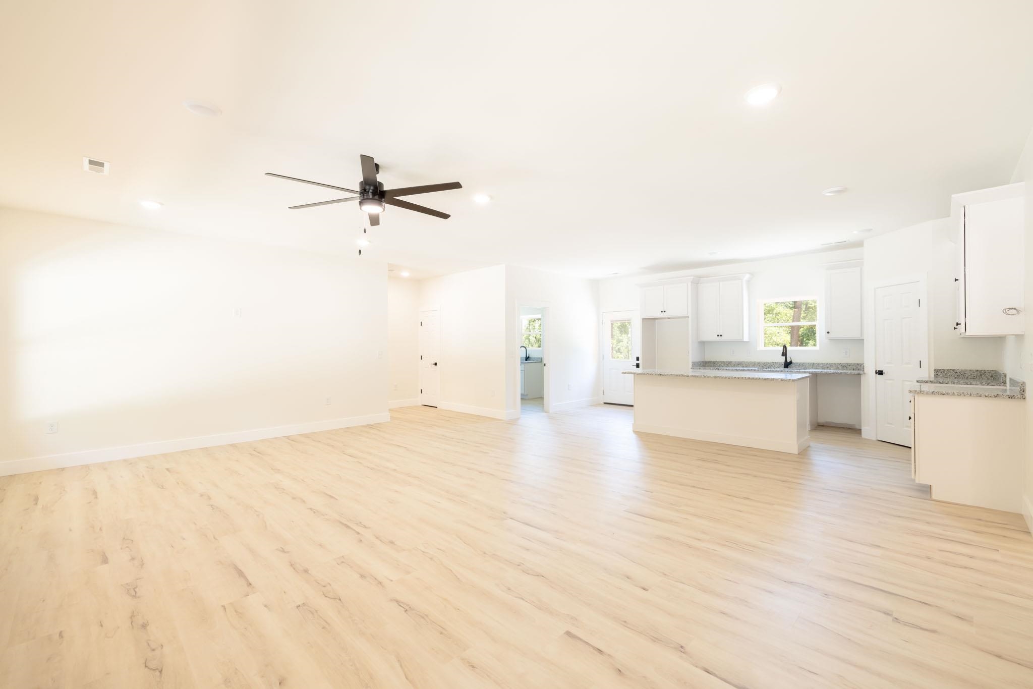 37 William Teague Lane Ramer, TN 38367 - Photo 14 of 39 Open-concept living space featuring wood-finish flooring, recessed lighting, and a dark-toned ceiling fan