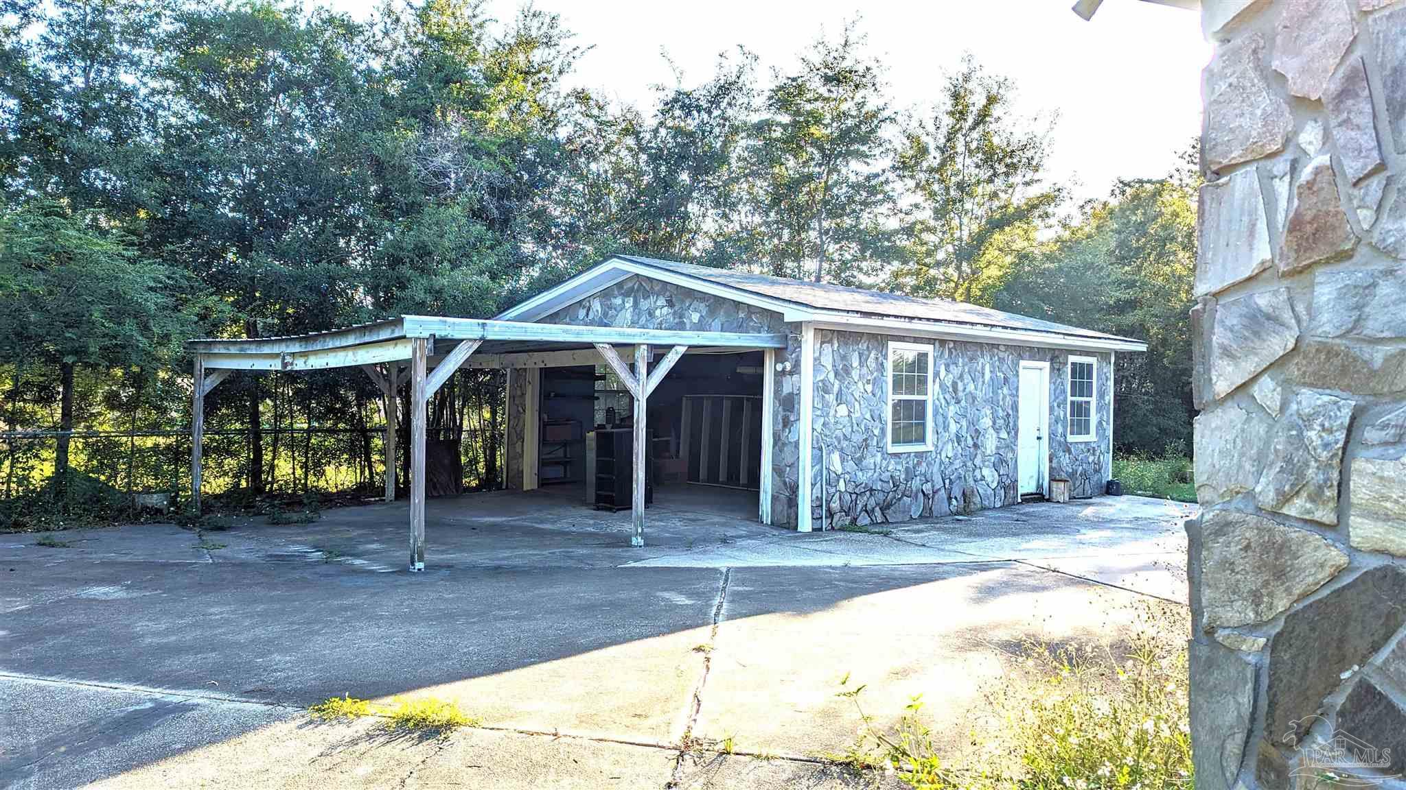 4312 Indiana Circle Pace, FL 32571 - Photo 2 of 21 2-car Detached Garage with Carport and Storage