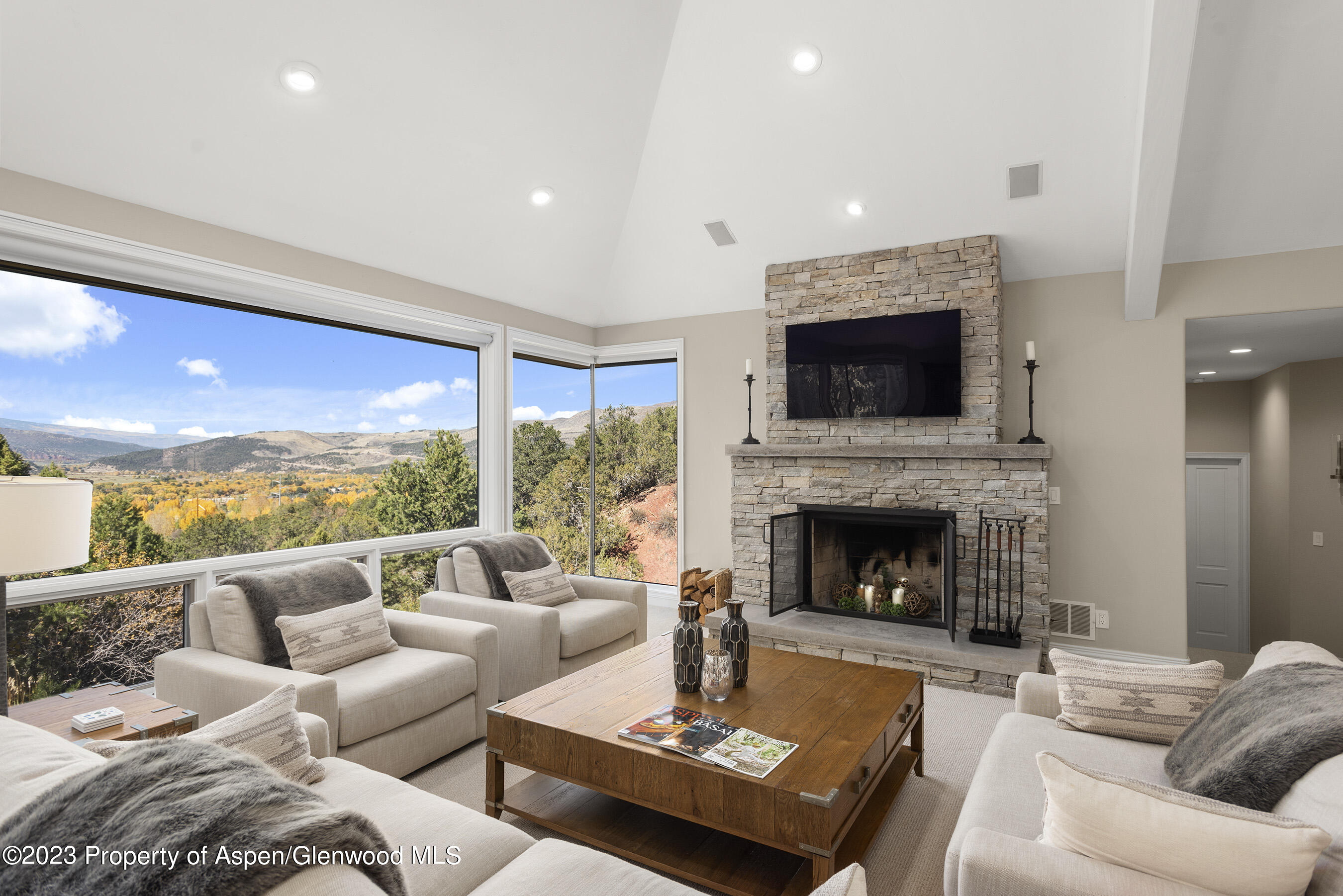 571 Booth Lane Basalt, CO 81621 - Photo 18 of 58 a living room with furniture a fireplace and a flat screen tv