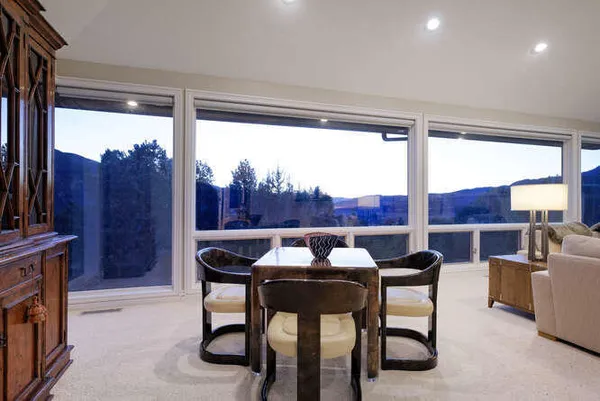 a living room with furniture a fireplace and a large window