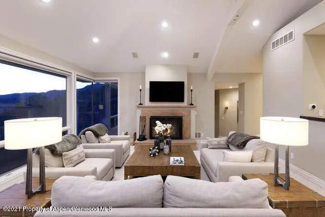 a kitchen with stainless steel appliances granite countertop a stove a sink a counter space and a center island