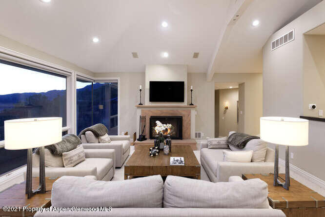 571 Booth Lane Basalt, CO 81621 - Photo 21 of 58 a living room with furniture a fireplace and a large window