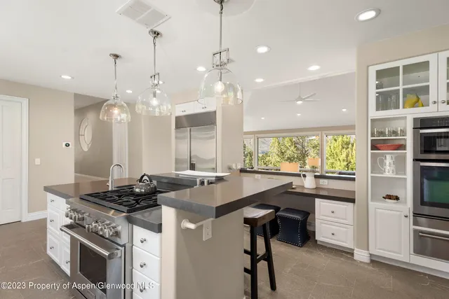 a kitchen with stainless steel appliances granite countertop a stove and a refrigerator