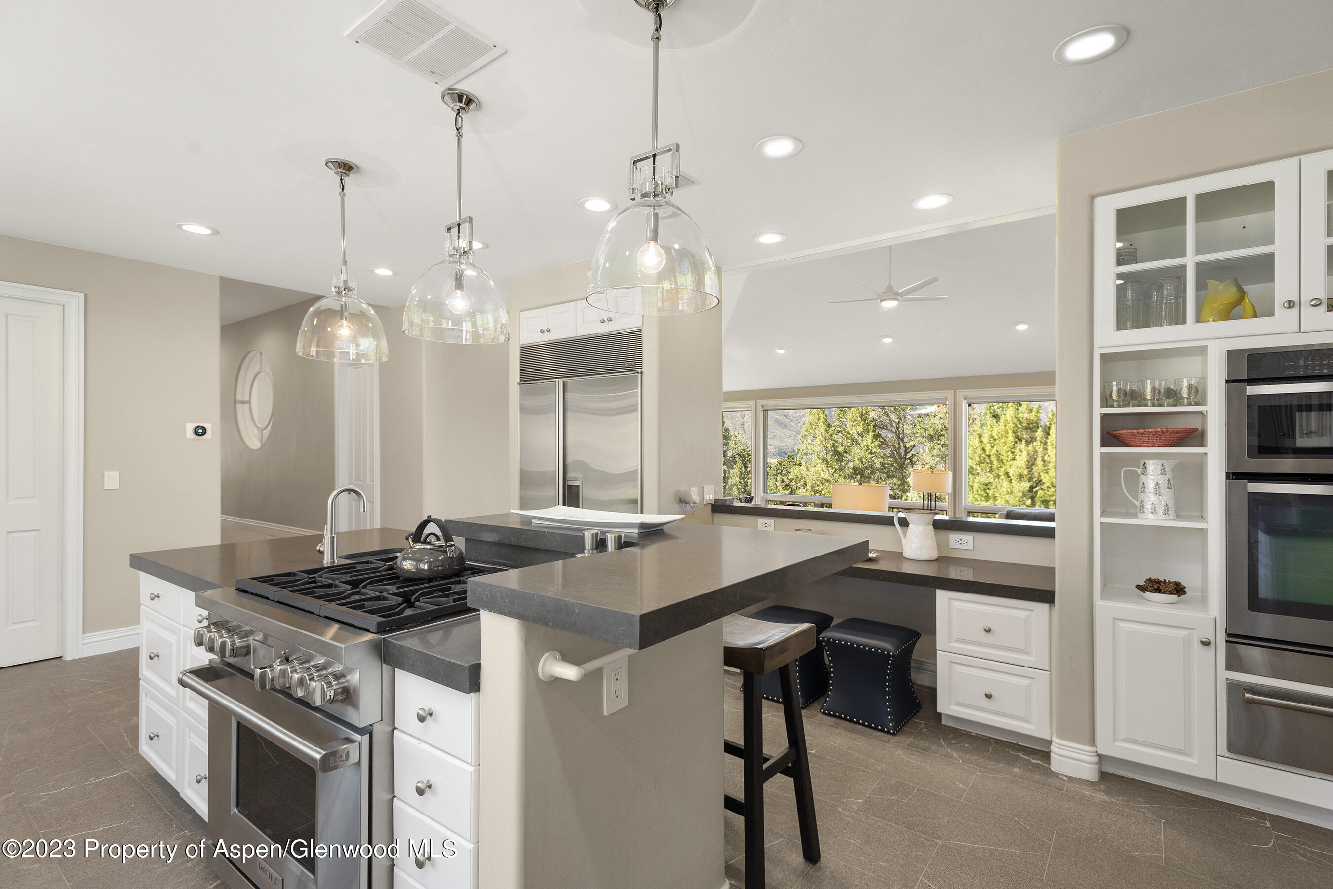 571 Booth Lane Basalt, CO 81621 - Photo 22 of 58 a kitchen with stainless steel appliances granite countertop a stove a sink a counter space and a center island