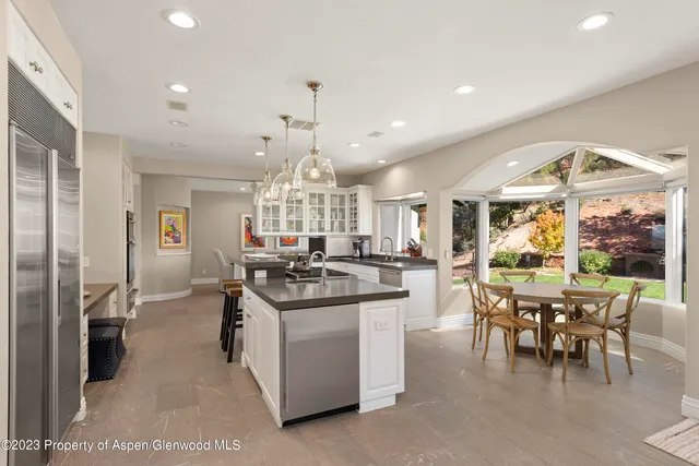 a kitchen with stainless steel appliances kitchen island granite countertop a sink and cabinets