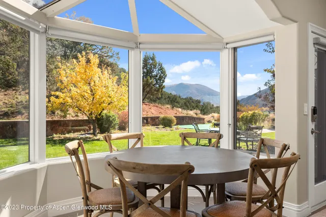 a living room with furniture a flat screen tv and a dining table