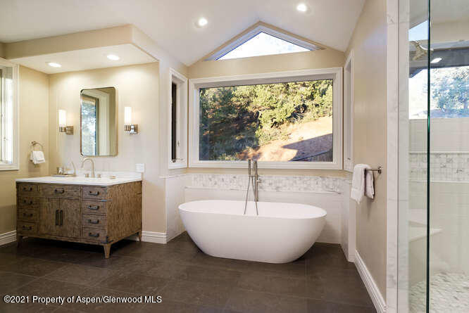 571 Booth Lane Basalt, CO 81621 - Photo 32 of 58 a spacious bathroom with a double vanity sink a mirror and a bathtub
