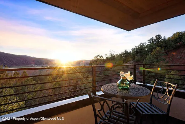 a view of a chairs and table in the balcony
