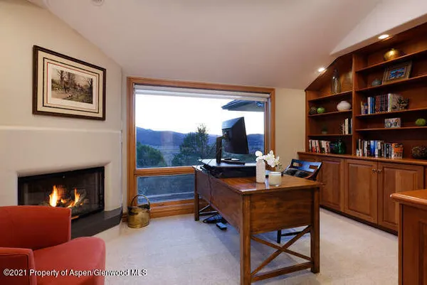 a bedroom with a bed couch and large window