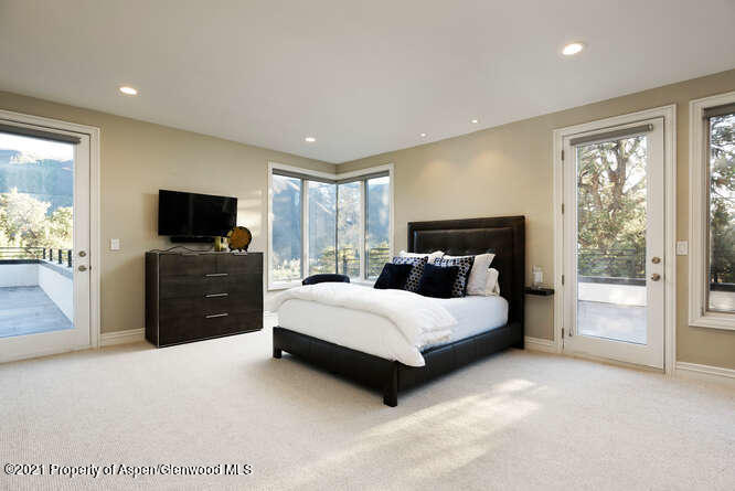 571 Booth Lane Basalt, CO 81621 - Photo 43 of 58 a spacious bedroom with a bed and a television