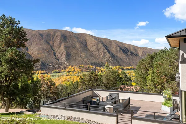 a bathroom with a granite countertop sink a toilet and a mirror