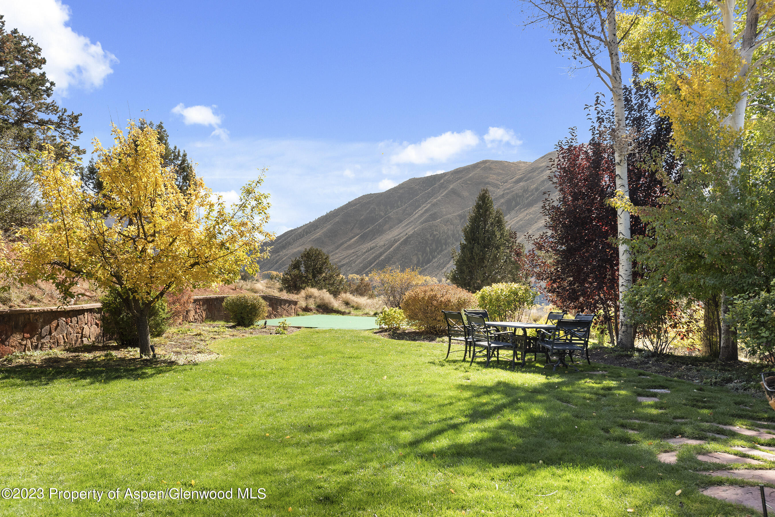 571 Booth Lane Basalt, CO 81621 - Photo 7 of 58 a backyard of a house with table and chairs