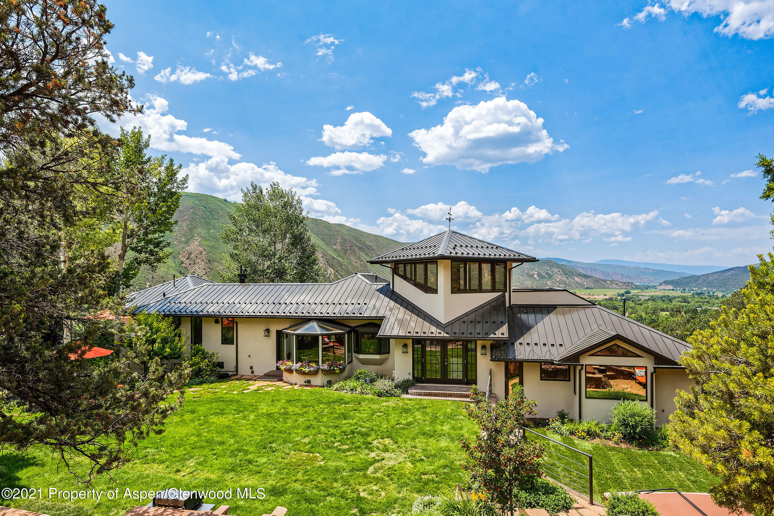 571 Booth Lane Basalt, CO 81621 - Photo 10 of 58 a front view of a house with a yard and garage