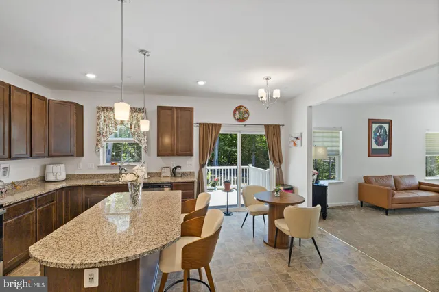 a view of a kitchen with a dining table and chairs