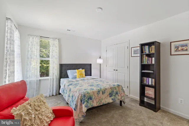 a bedroom with a bed furniture and a window