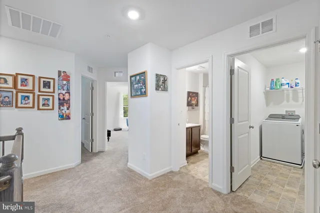 a view of a hallway with closet and bathroom