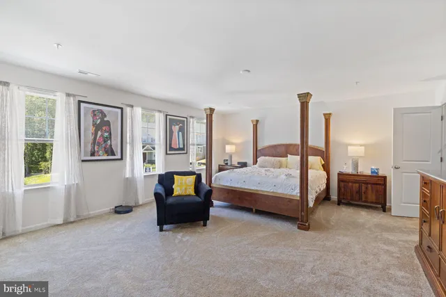 a bedroom with a bed couch and window