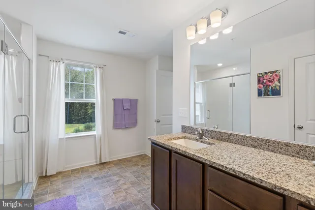 a view of a room with furniture and wooden floor