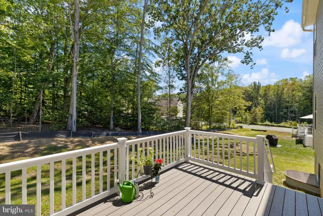 a backyard of a house with fountain table and chairs