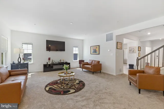a living room with furniture a couch and a flat screen tv