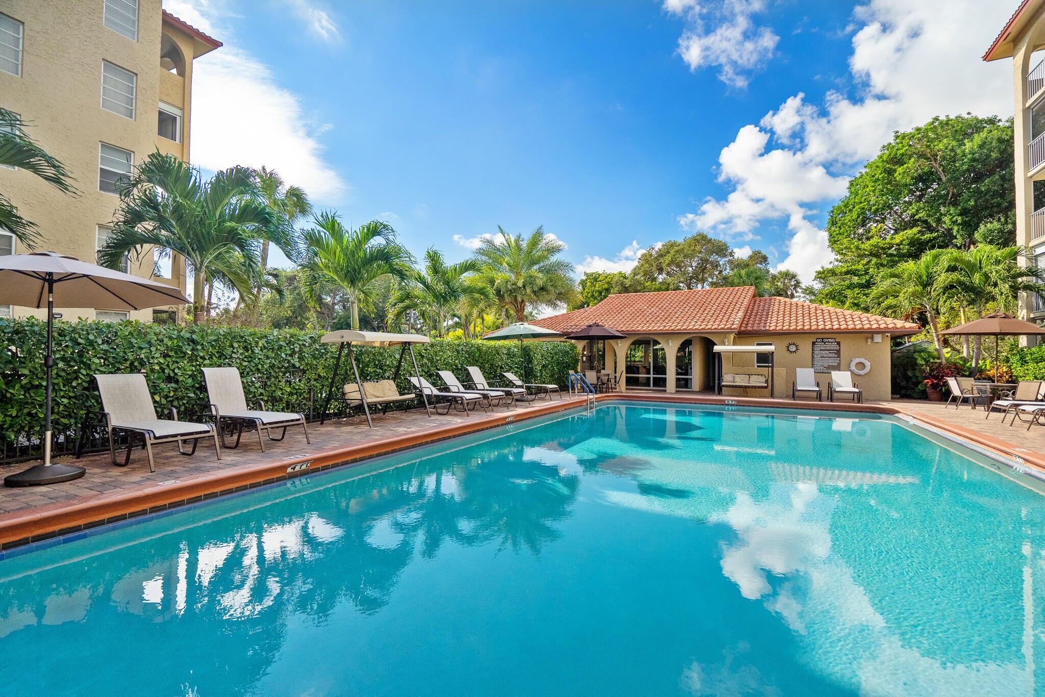 951 De Soto Road, Unit 130 Boca Raton, FL 33432 - Photo 27 of 38 a front view of house with yard and outdoor seating