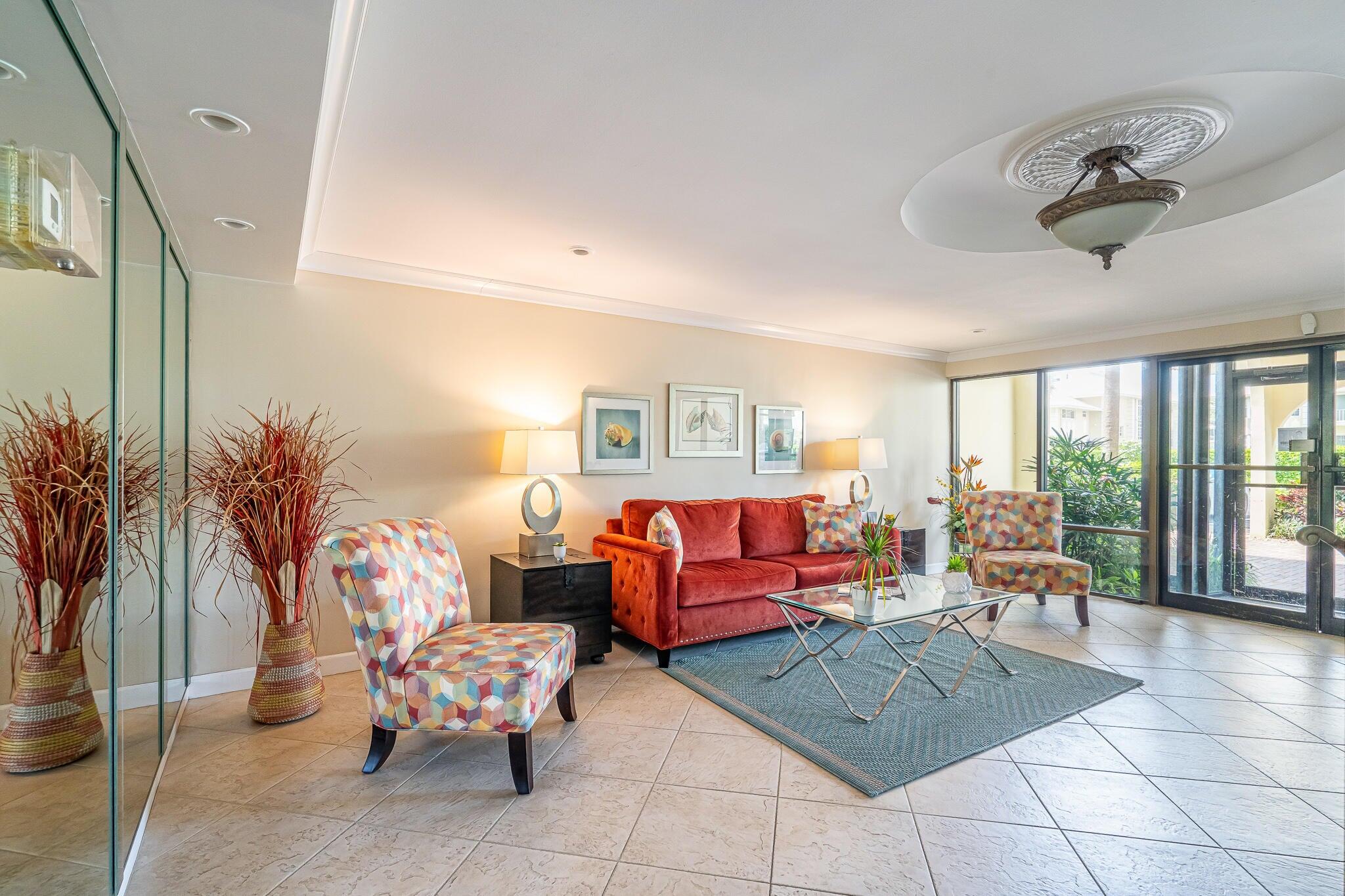951 De Soto Road, Unit 130 Boca Raton, FL 33432 - Photo 30 of 38 a living room with furniture and a large window