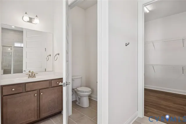a spacious bathroom with a toilet sink and mirror