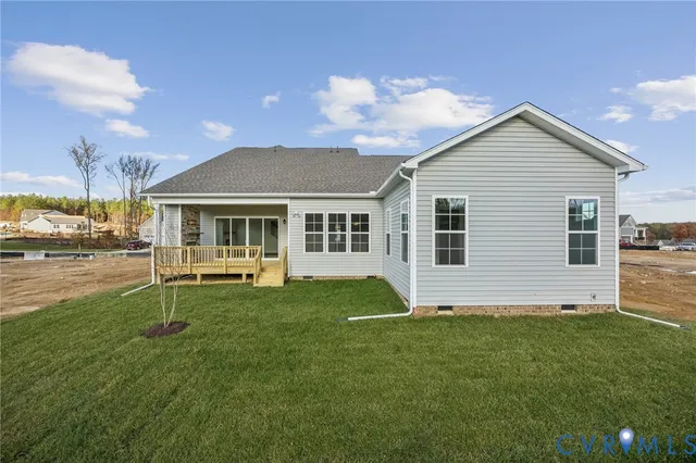 a view of a house with a yard and sitting area