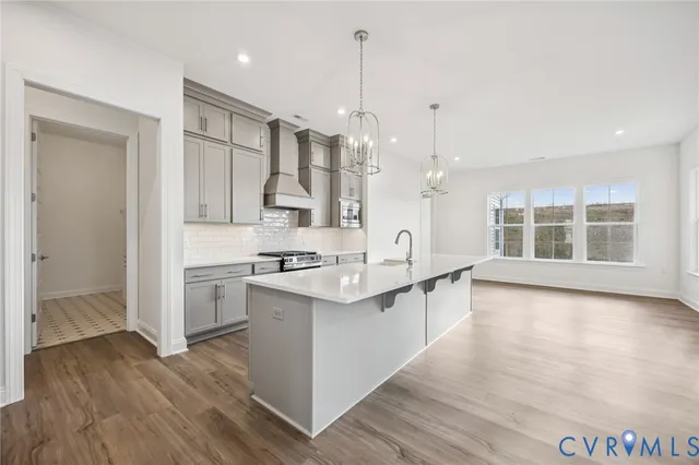 a kitchen with stainless steel appliances a sink stove and cabinets