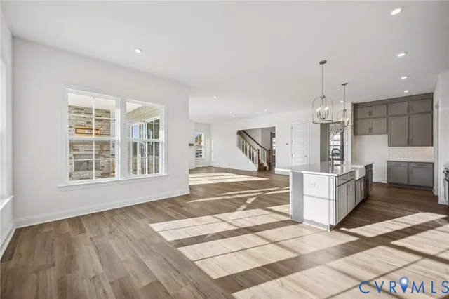 a view of kitchen with granite countertop sink and refrigerator
