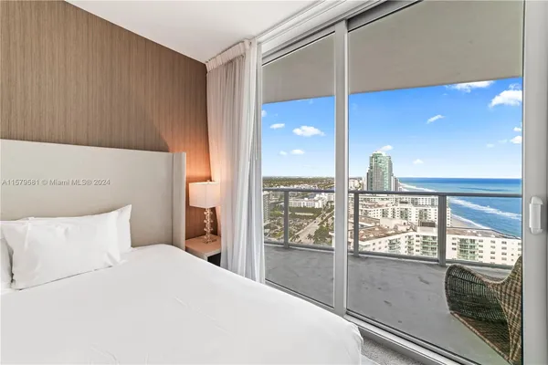 a bedroom with a large window and walk in closet