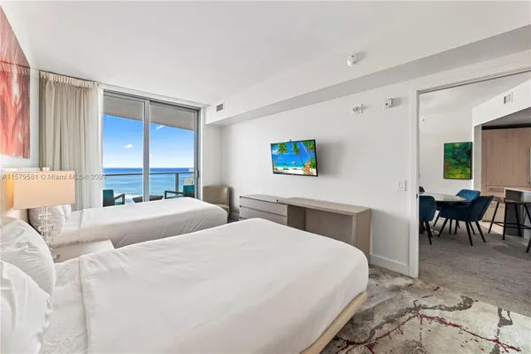 a bedroom with two beds and a couch