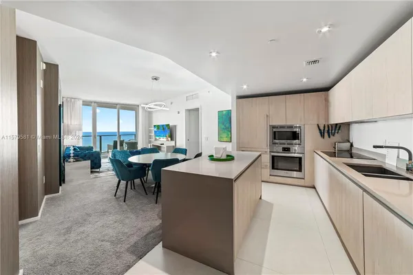 a kitchen with counter top space a sink appliances and cabinets