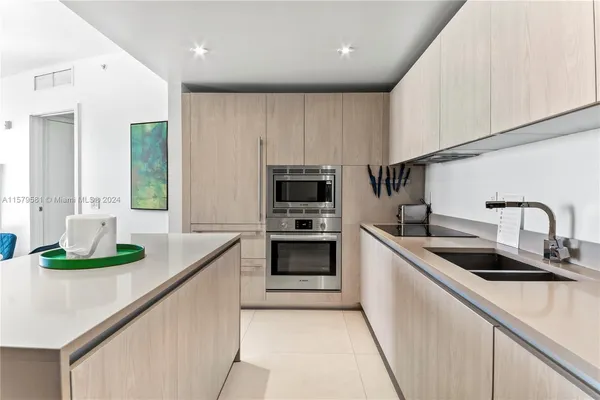 a kitchen with stainless steel appliances kitchen island granite countertop a sink and cabinets