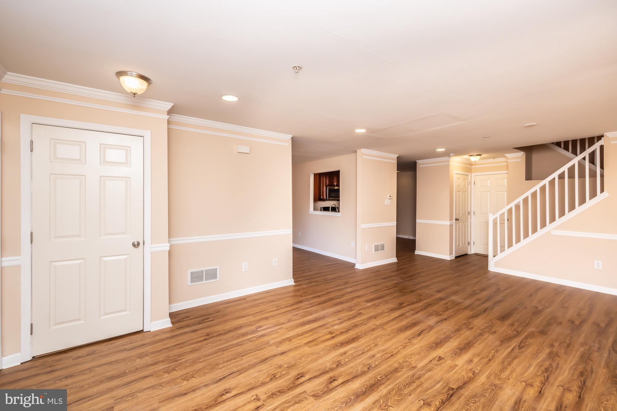 253 Flagstone Road, Unit 7 Chester Springs, PA 19425 - Photo 12 of 32 a view of an empty room with wooden floor and entryway