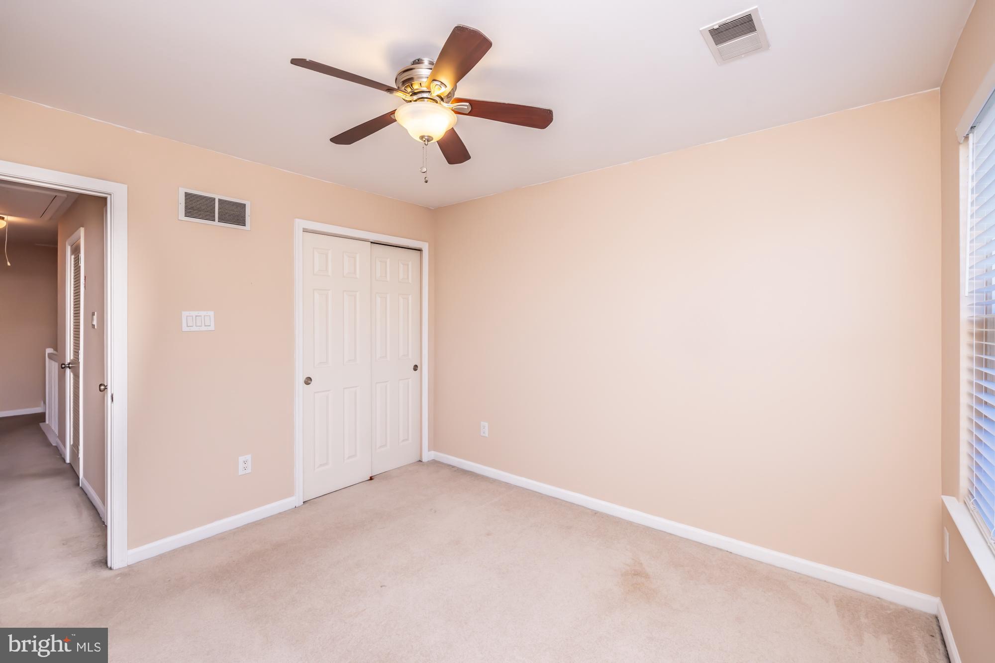 253 Flagstone Road, Unit 7 Chester Springs, PA 19425 - Photo 28 of 32 an empty room with a ceiling fan and a window