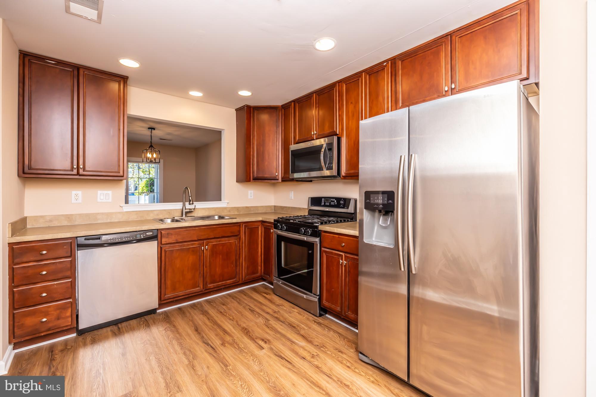 253 Flagstone Road, Unit 7 Chester Springs, PA 19425 - Photo 8 of 32 a kitchen with stainless steel appliances granite countertop a refrigerator stove and oven