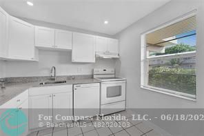 a kitchen with granite countertop a sink and cabinets