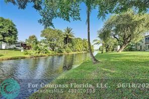 7605 Northwest 5th Place, Unit 101 Margate, FL 33063 - Photo 14 of 14 a view of a lake with a yard