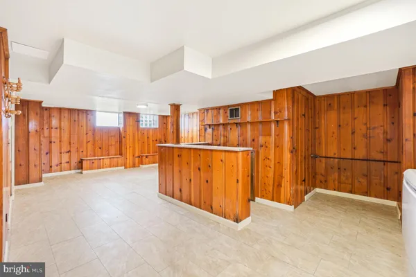 a view of an empty room with wooden walls