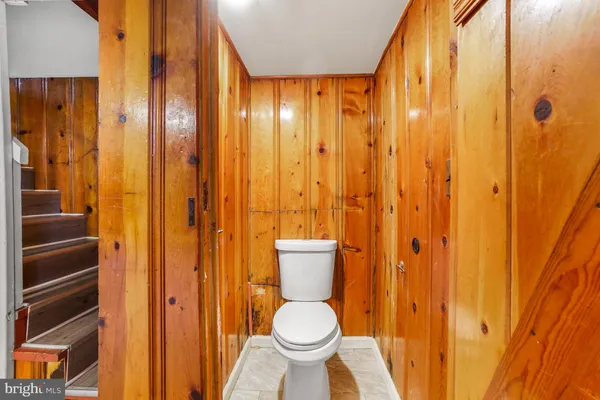 a bathroom with a toilet and shower curtain