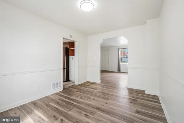 a view of a livingroom with wooden floor and window