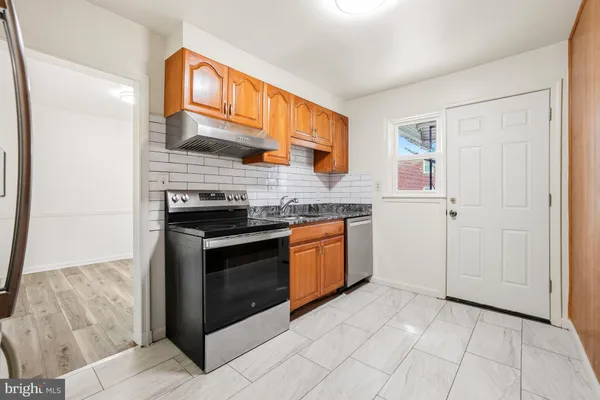 a kitchen with stainless steel appliances granite countertop a stove and a sink