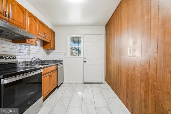 a kitchen with stainless steel appliances granite countertop a stove and a sink