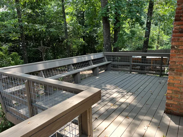 a view of backyard with deck and trees