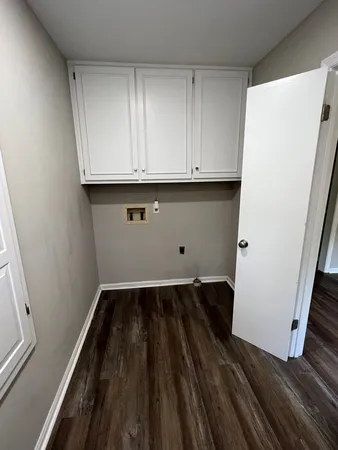 a view of storage and utility room with wooden floor