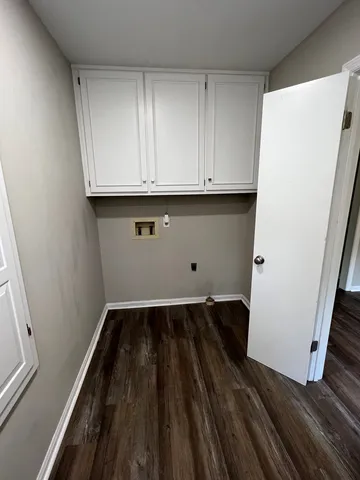 a view of storage and utility room with wooden floor