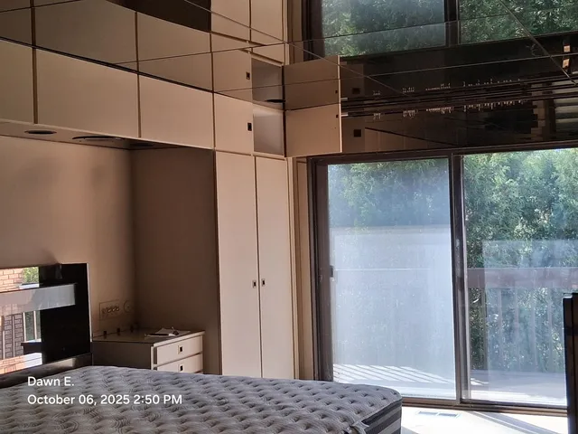 a bedroom with a bed and a mirror